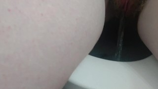 pissing young redhead with big tits pisses on webcam